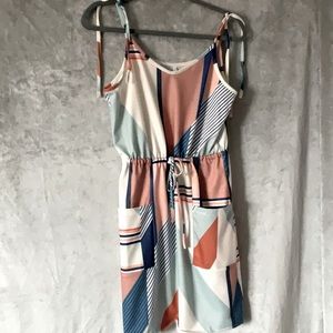 Summer dress with pockets.  Soft , muted colors of orange, tan,green, blue.